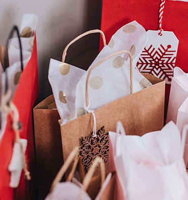 Luxury custom gift bags with rope handles and full-colour branding for retail packaging